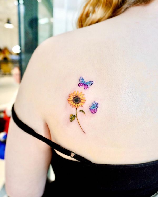 Feminine sunflower and butterflies tattoo by @kico.tattoo