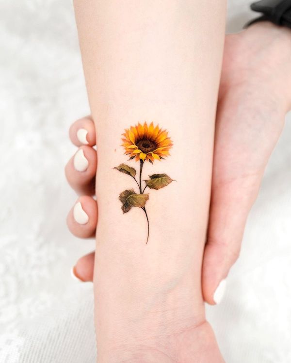 Small sunflower wrist tattoo by @donghwa_tattoo