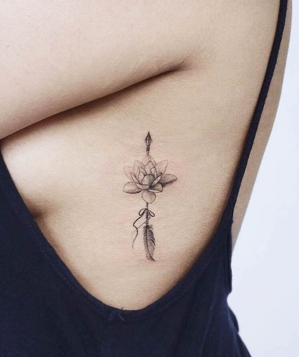 Arrow and lotus flower tattoo by @kaya_tattoo