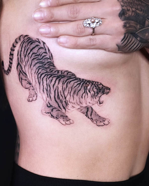Fierce tiger underboob tattoo by @moon.cheon