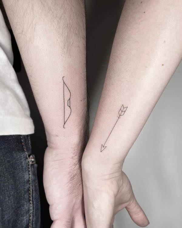 Matching bow and arrow couple tattoos by @fat_otherstyles