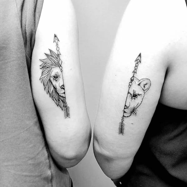 Matching lion arrow tattoos by @henrytattoo.art_