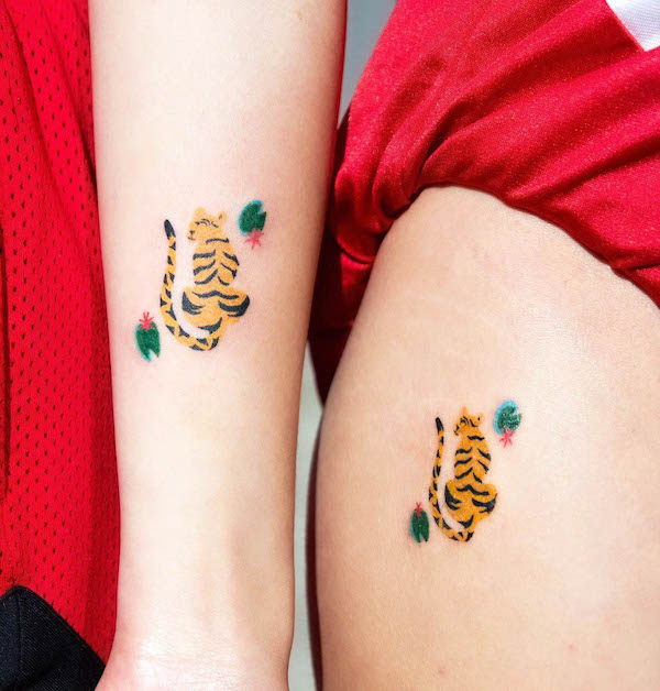Small matching tiger tattoos for best friends by @mopxistudio