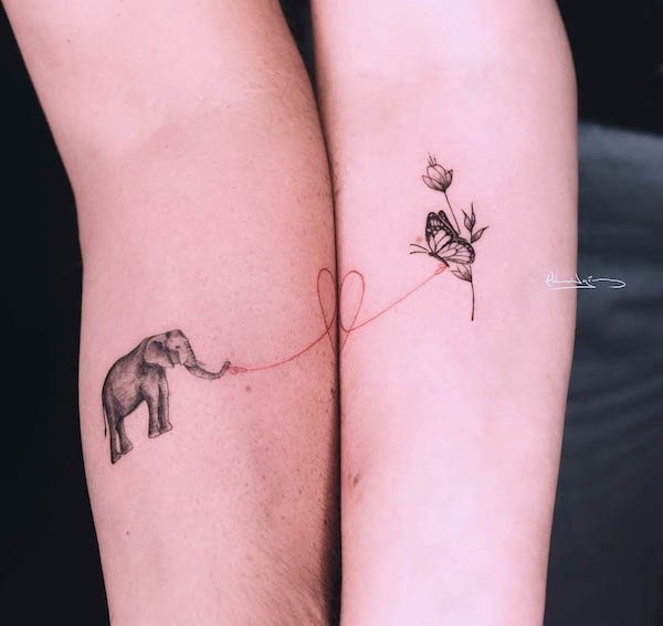 Elephant and butterfly matching tattoos by @edgomz