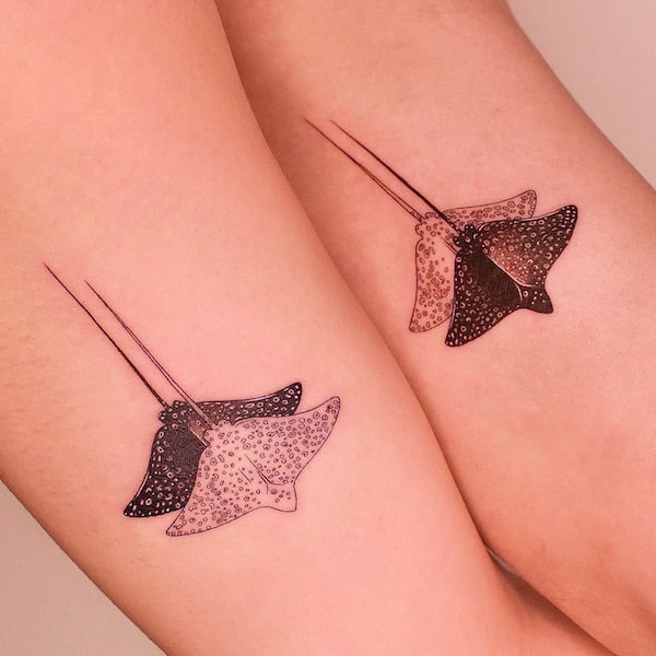 Matching manta ray tattoos by @tattooer_jina