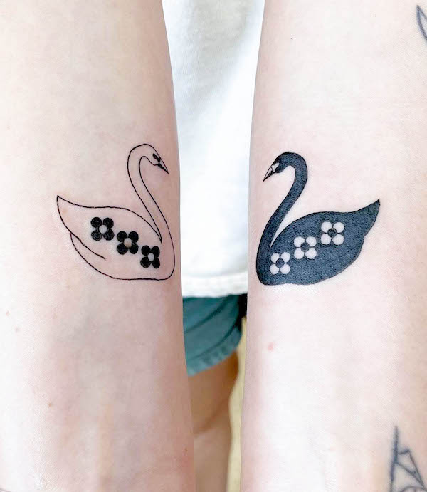 Black and white matching swan tattoos by @flowers.for_.all_.occasions