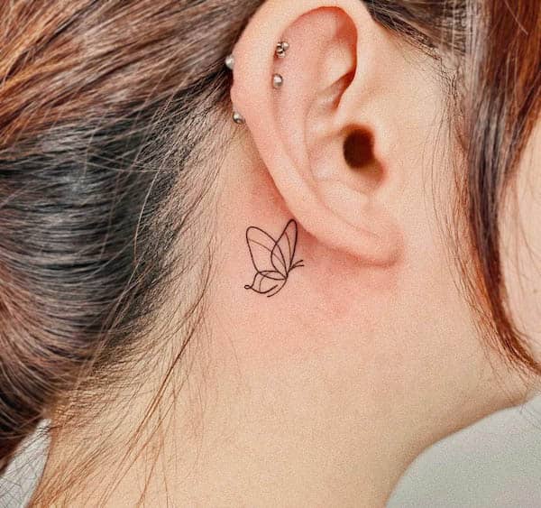 Fine-line butterfly behind the ear tattoo by @sun_line_moon