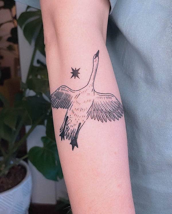 Flying swan with star tattoo by @linesbylau