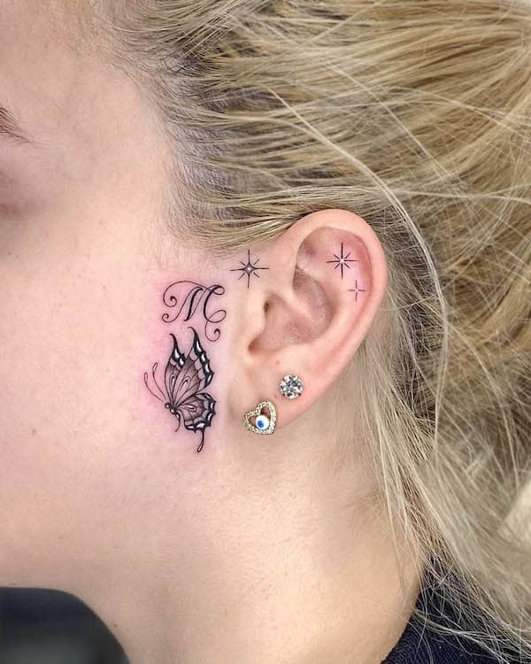 Initial and butterfly ear tattoo by @gabibaioto