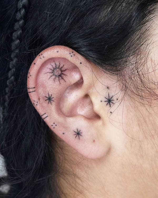 Simple sun and stars ear tattoo by @melpzvc