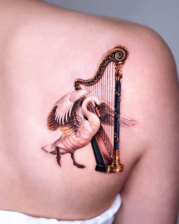 Swan and harp tattoo by @sorok.ink