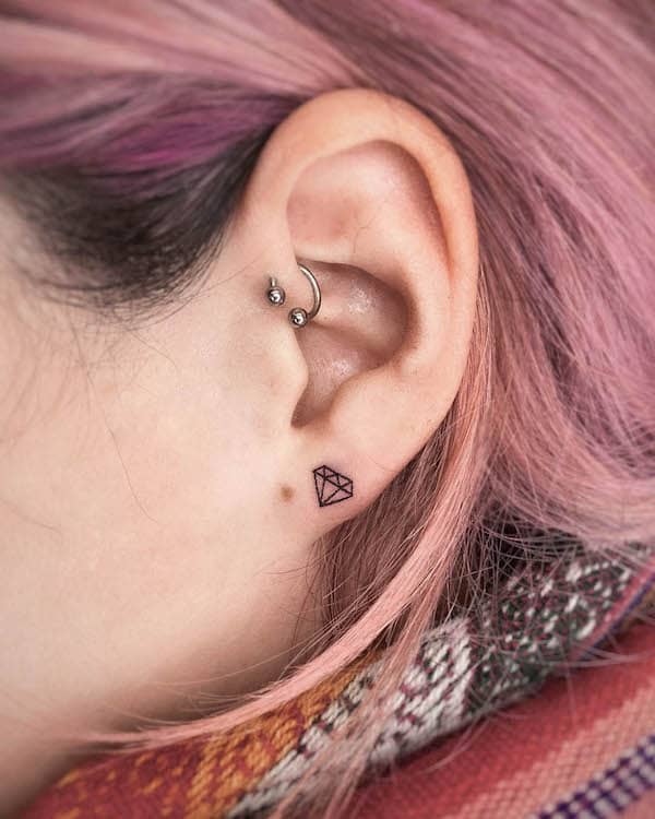 Tiny diamond ear tattoo by @trikona.tattoo