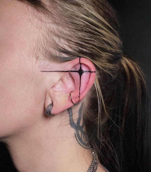Cross on the ear tattoo by @odetteolivarria