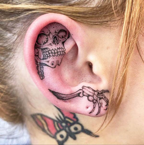 Creepy skeleton ear tattoo by @oldschooltattz