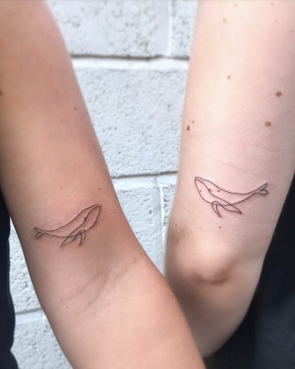 Matching minimalist whale tattoos by @sticks.not.stones